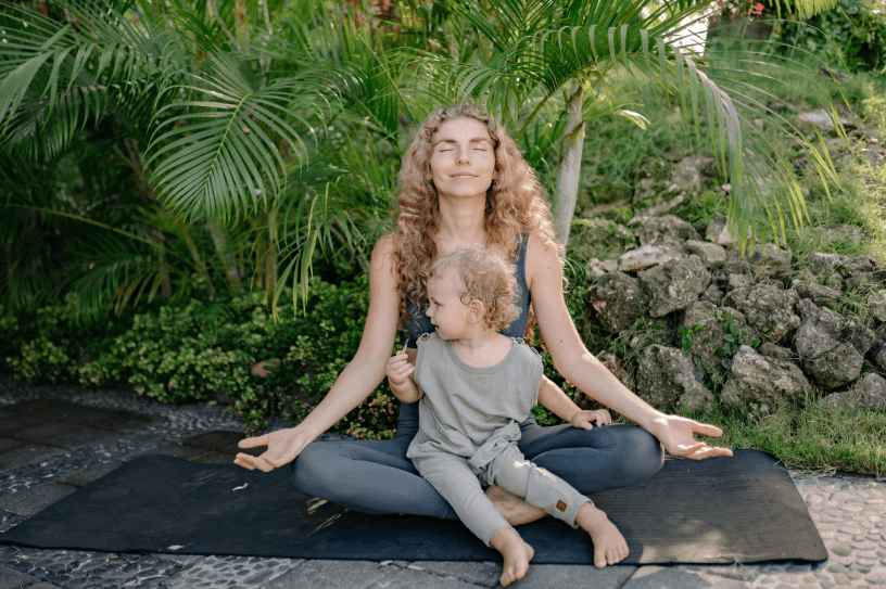 mother doing yoga with her child